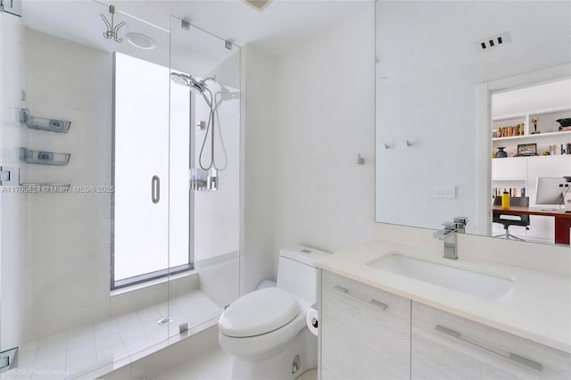 bathroom with visible vents, toilet, a shower stall, and vanity