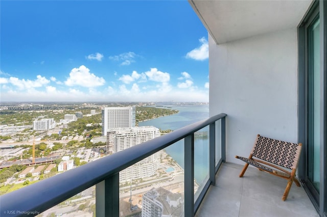 balcony with a water view and a city view