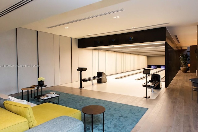 recreation room with hardwood / wood-style floors and bowling