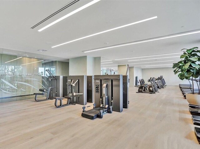 exercise room with wood finished floors