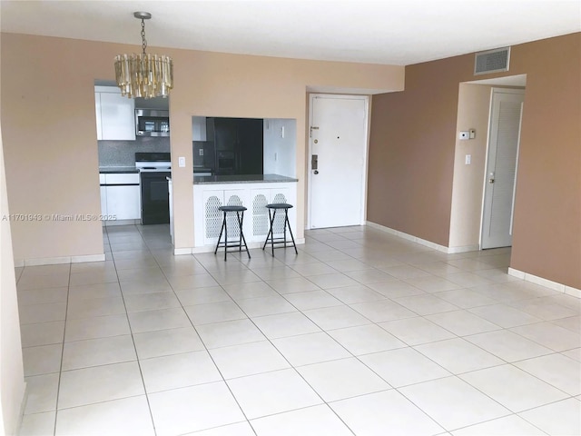 living room with a chandelier, baseboards, visible vents, and light tile patterned floors