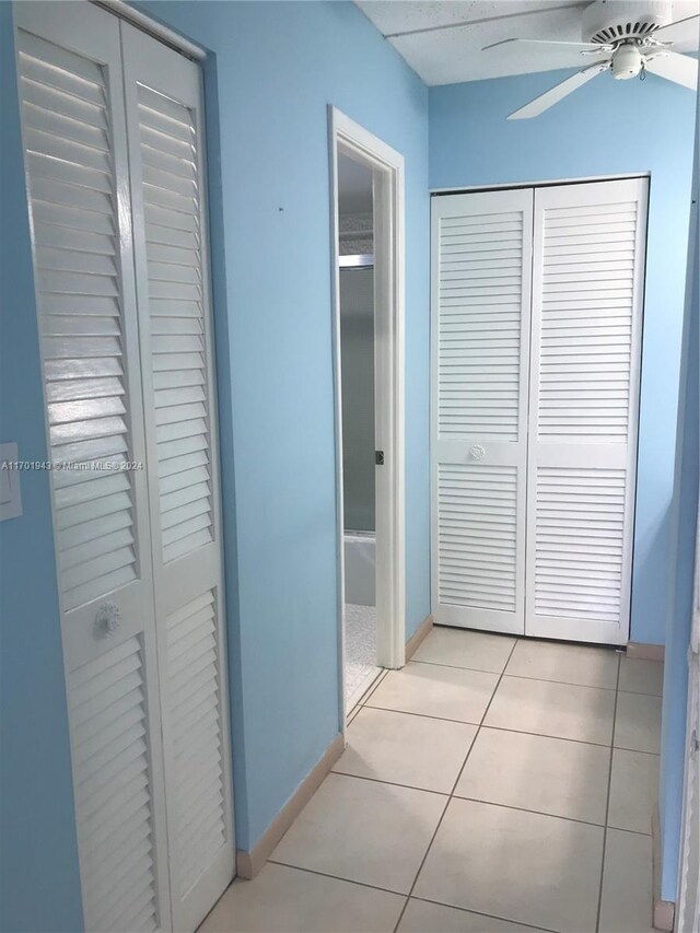 hall with light tile patterned floors