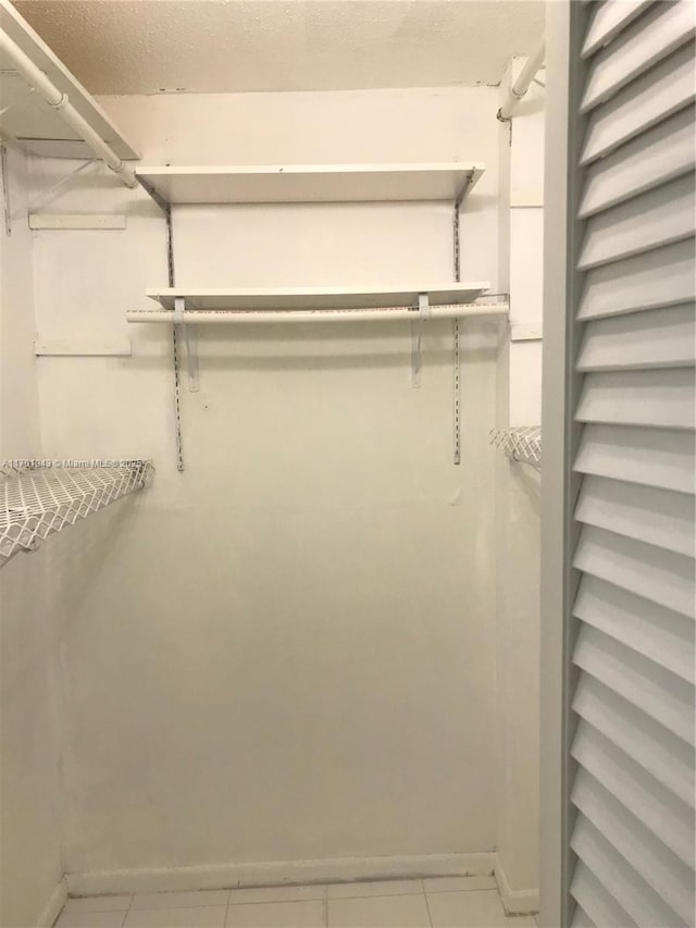 spacious closet featuring tile patterned flooring