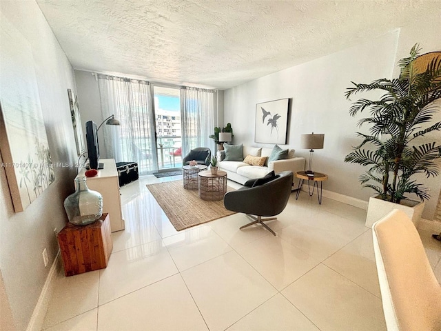 living room featuring expansive windows, light tile patterned floors, and a textured ceiling