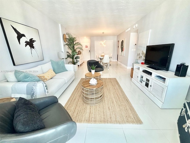 living room with light tile patterned floors and a textured ceiling