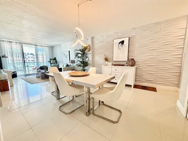 tiled dining room with a wall of windows