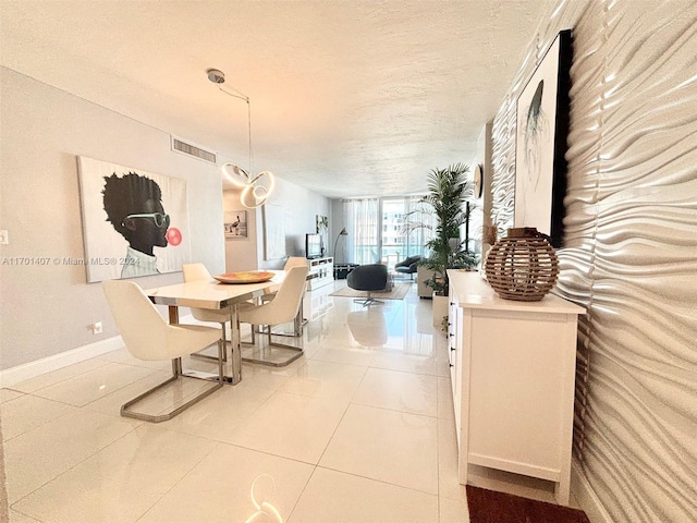 tiled dining area with a textured ceiling