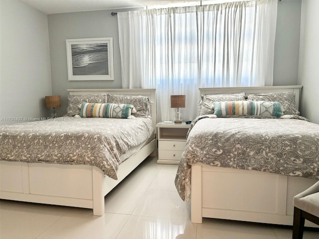 bedroom with light tile patterned floors