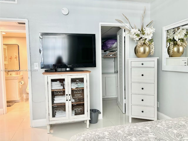 tiled bedroom with connected bathroom