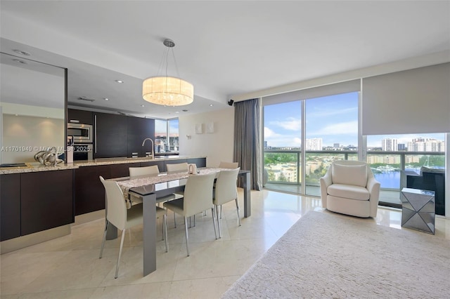 dining room featuring a wall of windows and sink