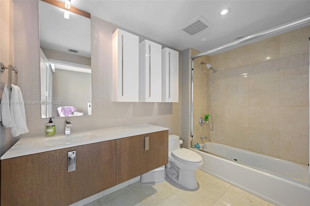 full bathroom featuring tiled shower / bath combo, tile patterned flooring, backsplash, toilet, and vanity