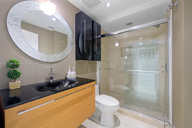 bathroom with tile patterned floors, vanity, toilet, and a shower with door