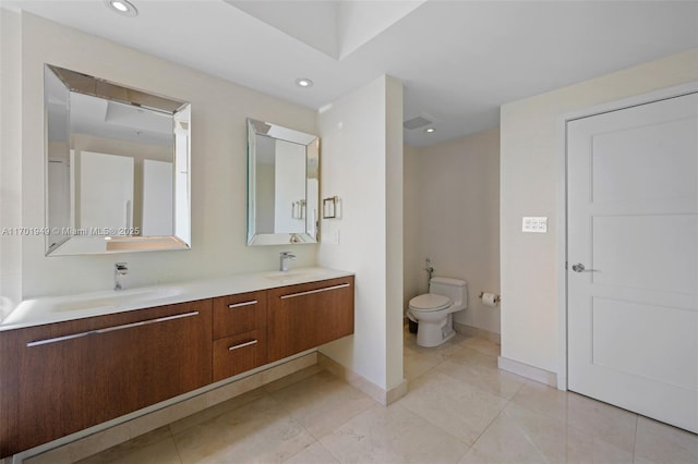 bathroom featuring tile patterned floors, vanity, and toilet