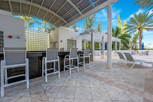 view of patio / terrace with a pergola and exterior bar