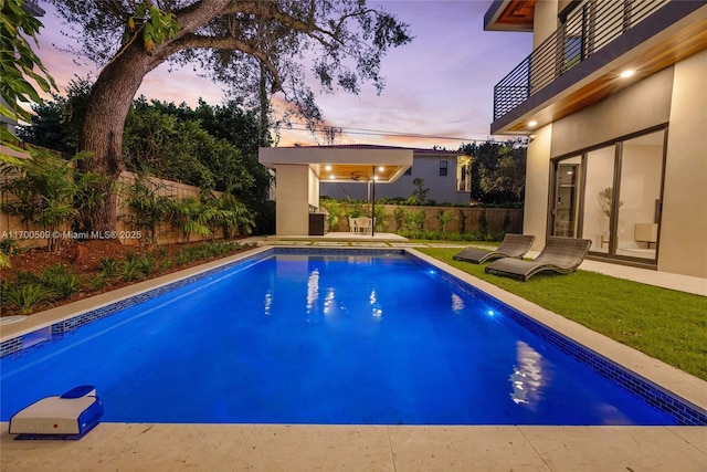 view of pool at dusk