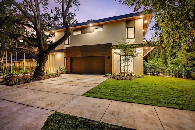 modern home with a garage and a lawn