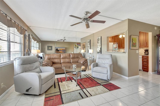 tiled living room featuring a textured ceiling and ceiling fan