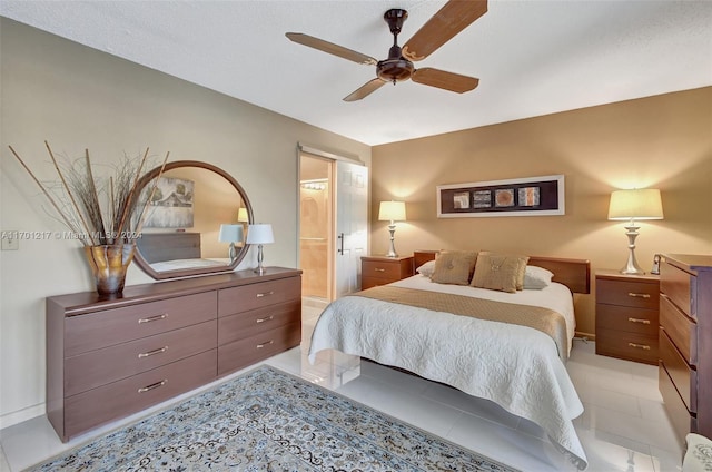 tiled bedroom with ensuite bathroom and ceiling fan