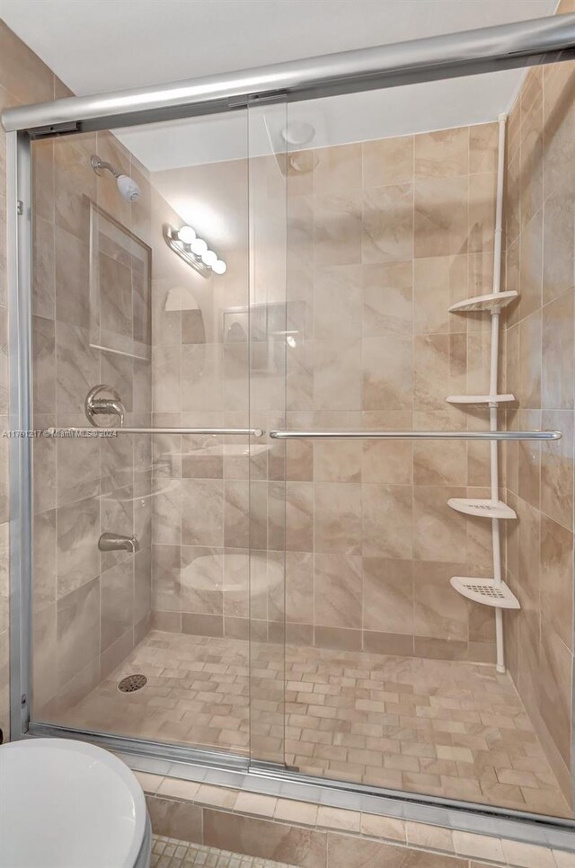 bathroom featuring a shower with shower door