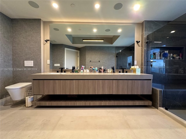 bathroom with vanity, toilet, and a shower with shower door