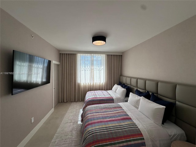 bedroom featuring light colored carpet