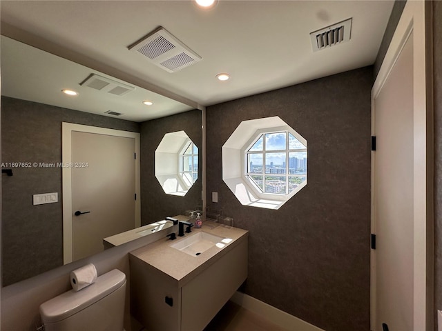 bathroom with vanity and toilet