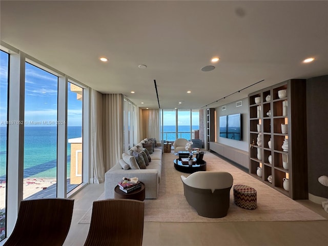 living room featuring a water view, a wall of windows, and track lighting