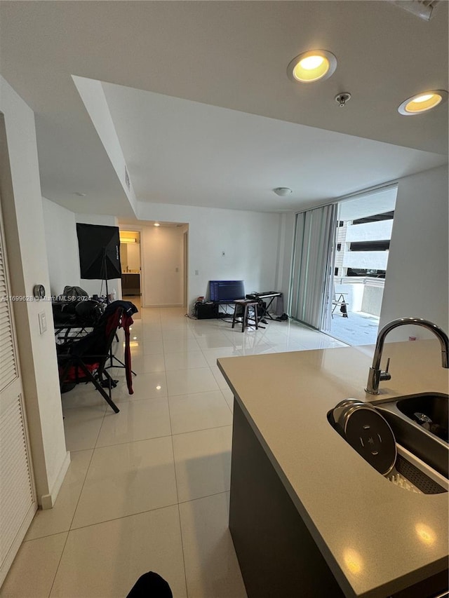 kitchen featuring light tile patterned floors and sink