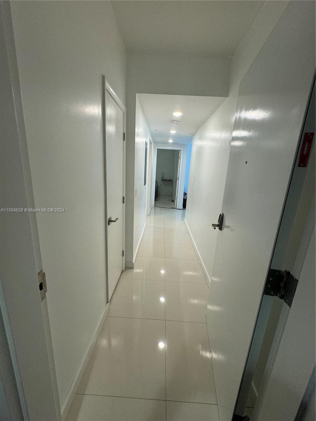 hall with light tile patterned floors