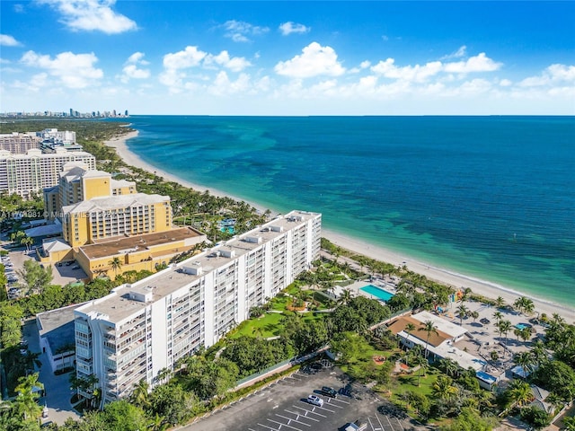 drone / aerial view with a beach view and a water view