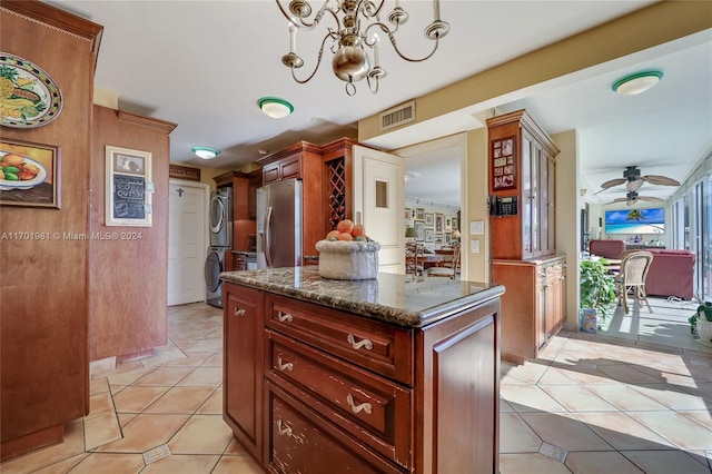 605 Ocean Dr Unit 4L, Key Biscayne, FL 33149 - kitchen featuring stacked washer / drying machine, stainless steel refrigerator with ice dispenser, light tile patterned floors, a ceiling fan, and dark stone countertops