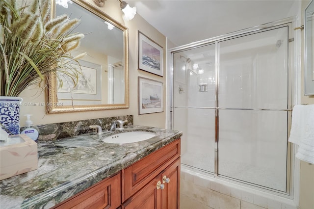 bathroom with a shower with door and vanity