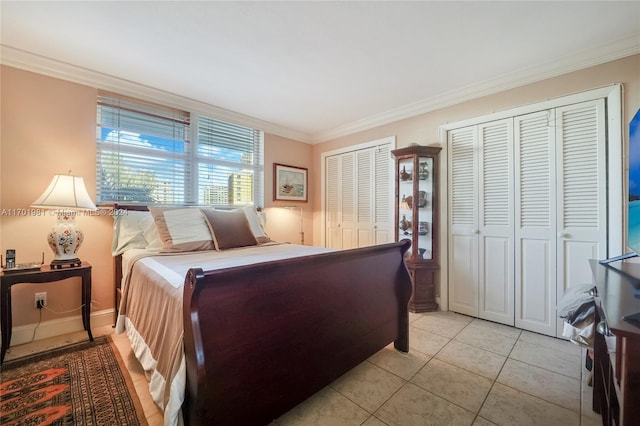 605 Ocean Dr Unit 4L, Key Biscayne, FL 33149 - bedroom featuring multiple closets, ornamental molding, and light tile patterned flooring