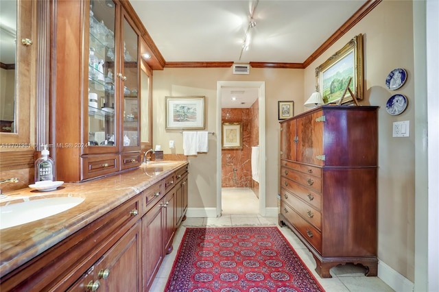 bathroom featuring vanity, a shower, track lighting, tile patterned floors, and crown molding