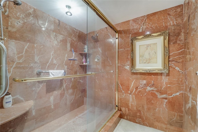 bathroom with an enclosed shower and tile walls