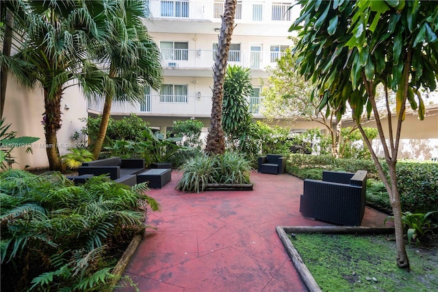 view of home's community with an outdoor hangout area and a patio