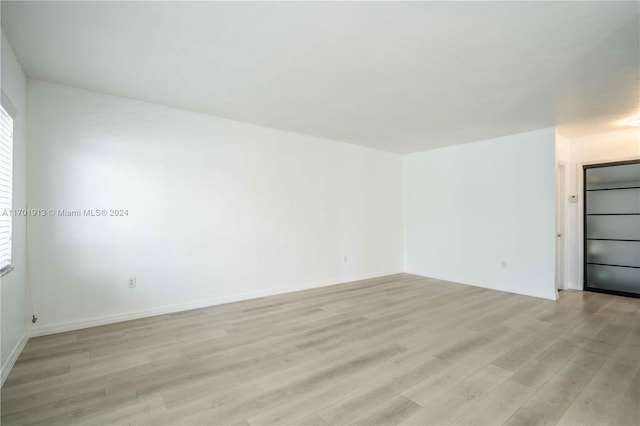 empty room with light hardwood / wood-style floors