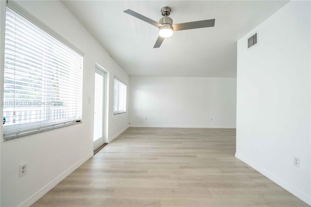 empty room featuring light wood-type flooring and ceiling fan