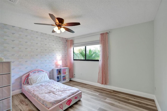 bedroom featuring a textured ceiling, hardwood / wood-style flooring, and ceiling fan