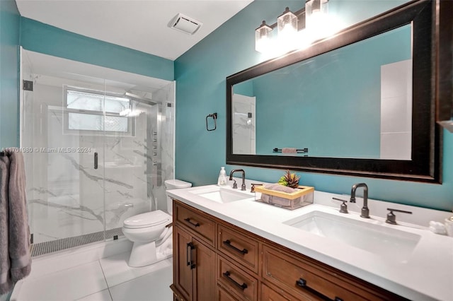 bathroom featuring tile patterned flooring, vanity, a shower with door, and toilet