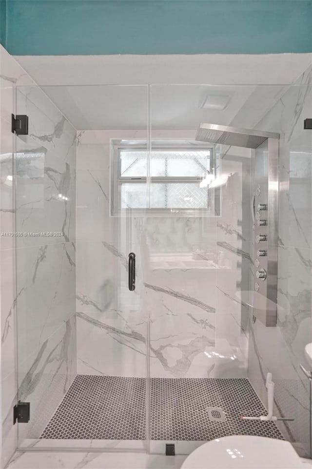 bathroom with toilet and an enclosed shower