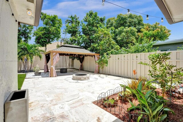 view of patio / terrace featuring a gazebo and an outdoor fire pit