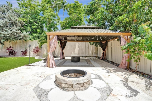 view of patio featuring a gazebo and a fire pit