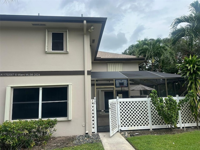 back of house featuring a lanai