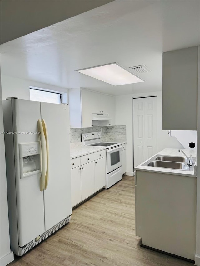 kitchen featuring decorative backsplash, white appliances, sink, light hardwood / wood-style flooring, and white cabinetry