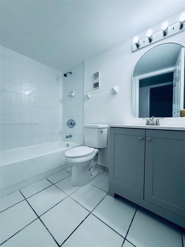 full bathroom with tile patterned flooring, vanity, toilet, and tiled shower / bath