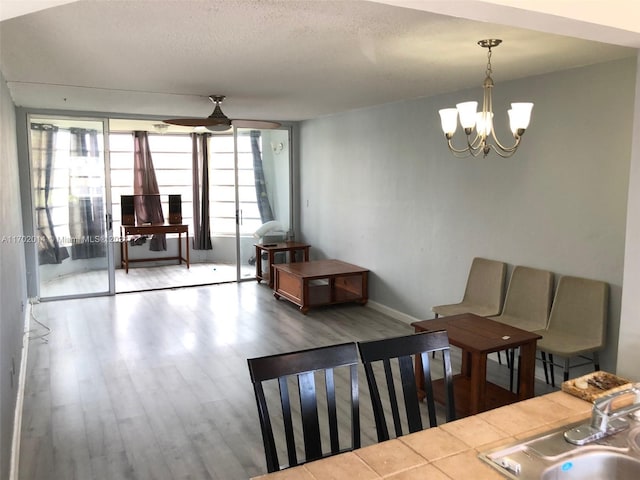 18900 NE 14th Ave Unit D204, Miami, FL 33179 - dining area with a chandelier, wood finished floors, and baseboards
