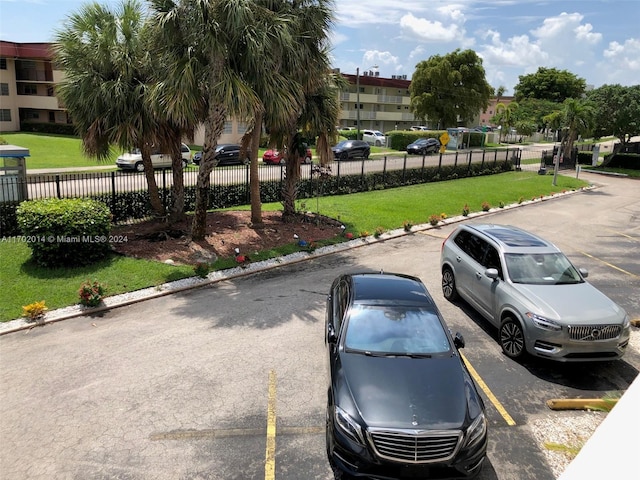 view of parking featuring a lawn