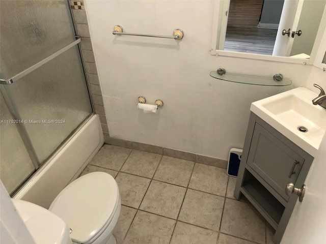 full bathroom featuring tile patterned flooring, vanity, toilet, and enclosed tub / shower combo