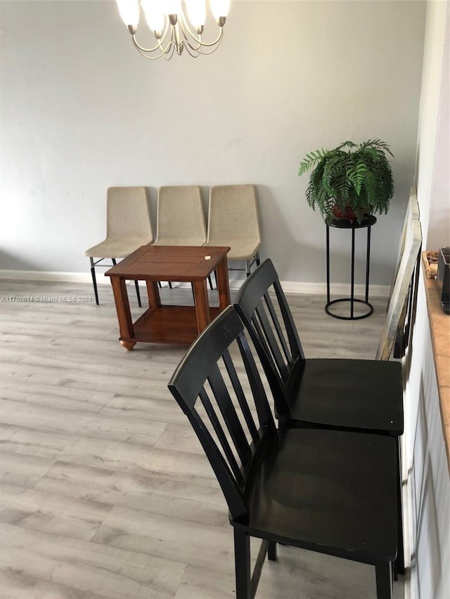 18900 NE 14th Ave Unit D204, Miami, FL 33179 - dining space featuring baseboards, light wood-style flooring, and a chandelier